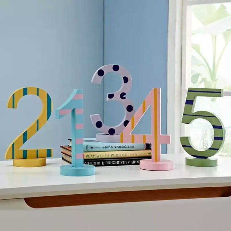 Colorful wooden numbers 1-5. Playful decor for kids' room or educational use.