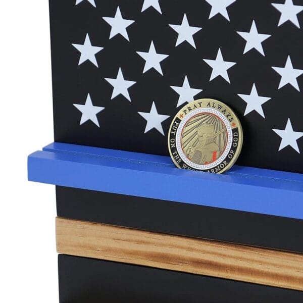 Thin Blue Line wooden display shelf with US flag design and "Pray Always" challenge coin.