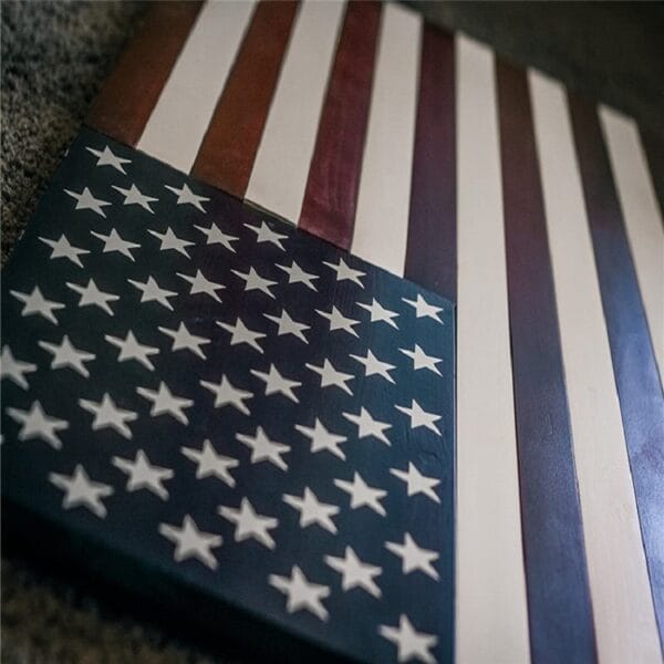 Wooden American flag decor featuring carved stars and painted stripes.