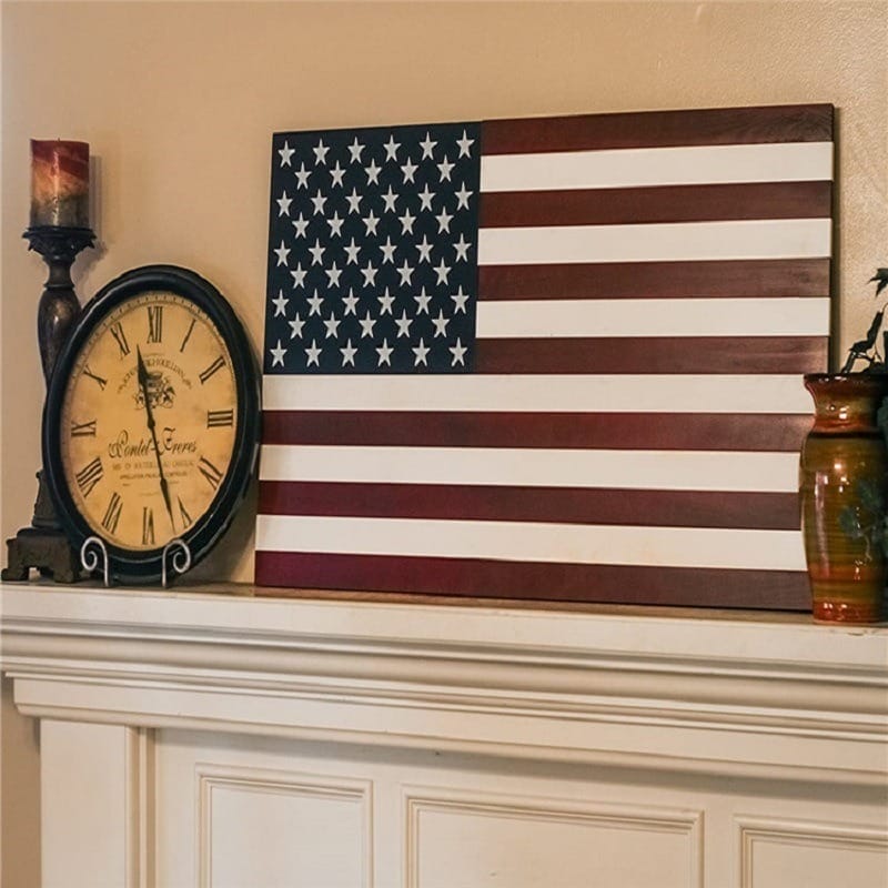 Wooden American flag art with vintage clock and candle decor