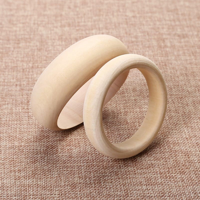 Two unfinished wooden bangles, one wide and one narrow, for crafting or jewelry making