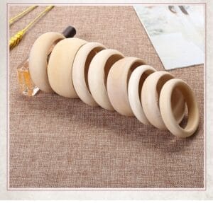 Unfinished wooden bangles in varying sizes, crafting supplies for jewelry making.