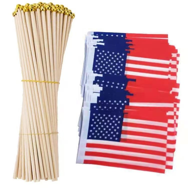 AUTO-DRAFT: Bundle of wooden sticks and stack of small American flags