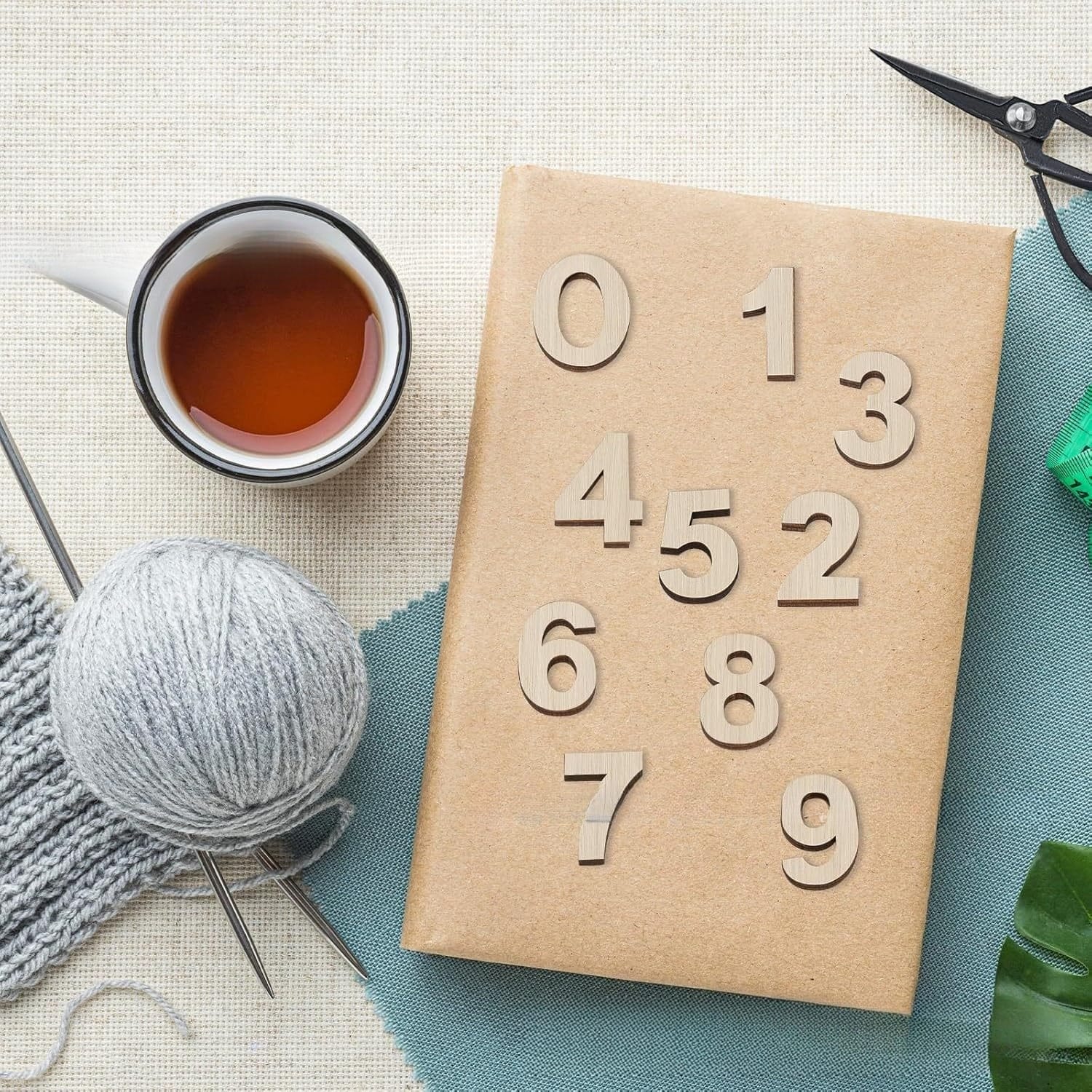 Bulk Wooden Numbers Craft Set on package with knitting, tea, and scissors. DIY painting, nursery decor.