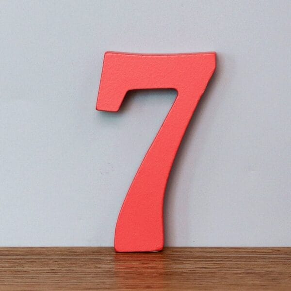 Red wooden number 7, a decorative numeral for learning or home decor.