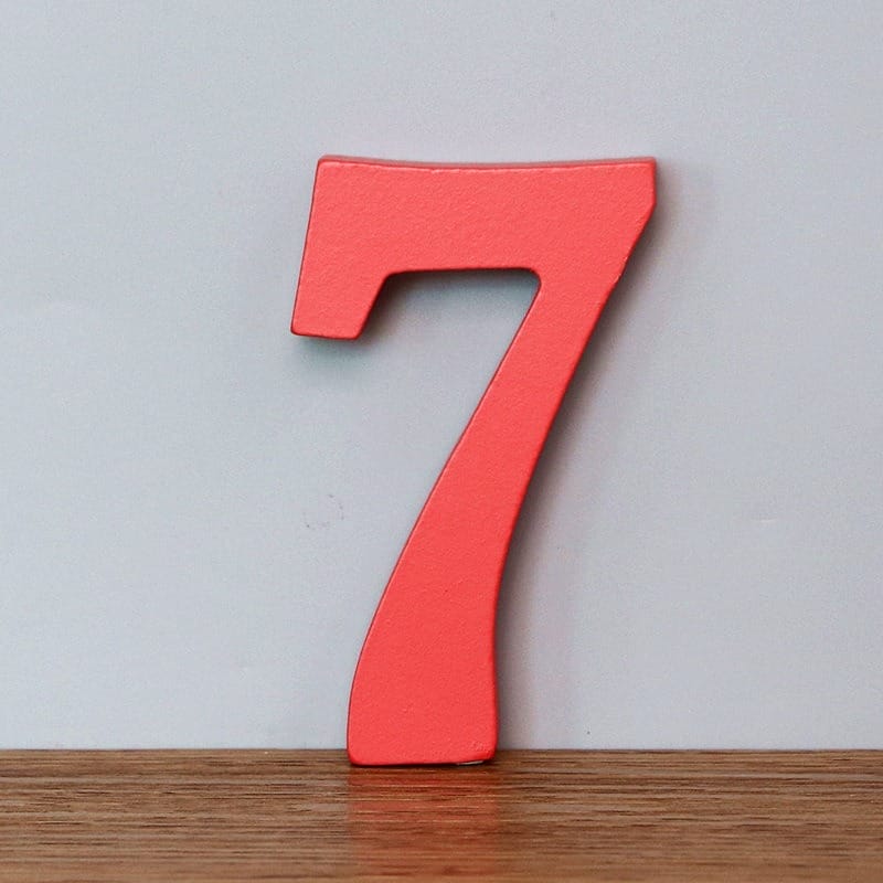 Red wooden number 7, a decorative numeral for learning or home decor.