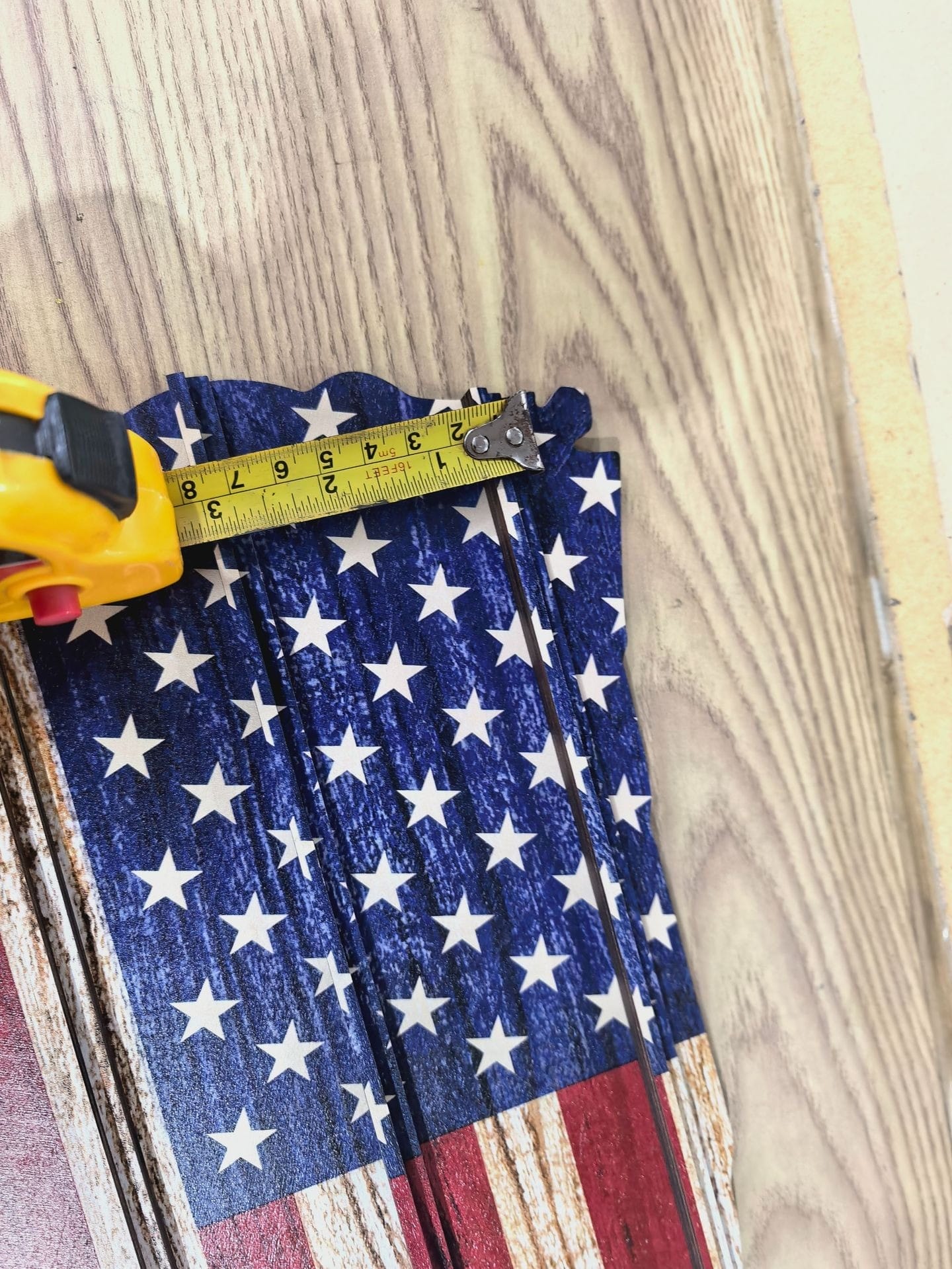 Custom Wooden US Flag Display Rack: Rustic American flag keepsake organizer, showing width with tape measure.