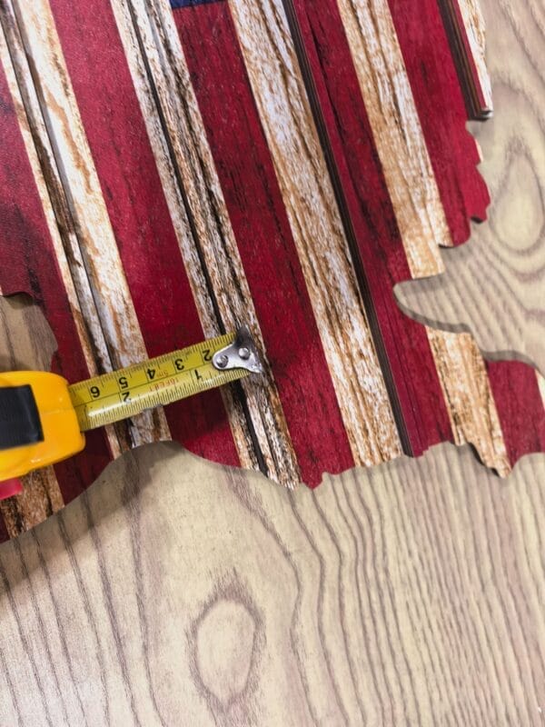 Custom Wooden US Flags Badge & Coin Display Rack. Rustic American flag detail with tape measure showing size.