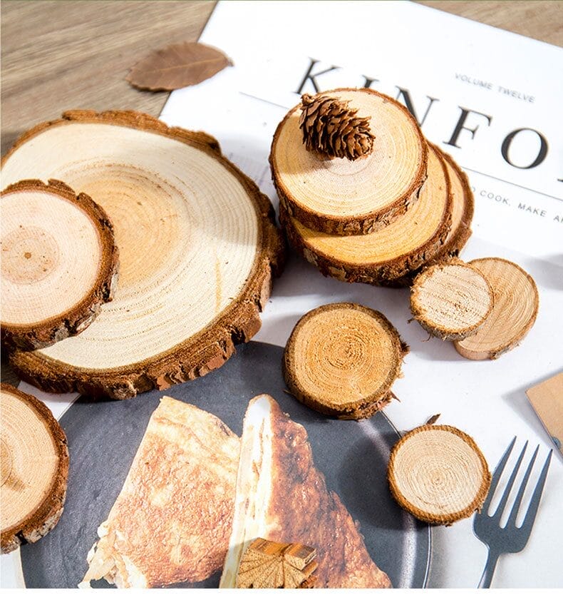 Wood slices of varying sizes with bark edges, some stacked, on a magazine page with food.