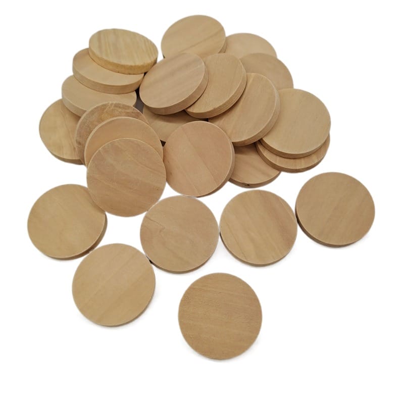 Pile of small, unfinished round wooden discs for crafts or games.