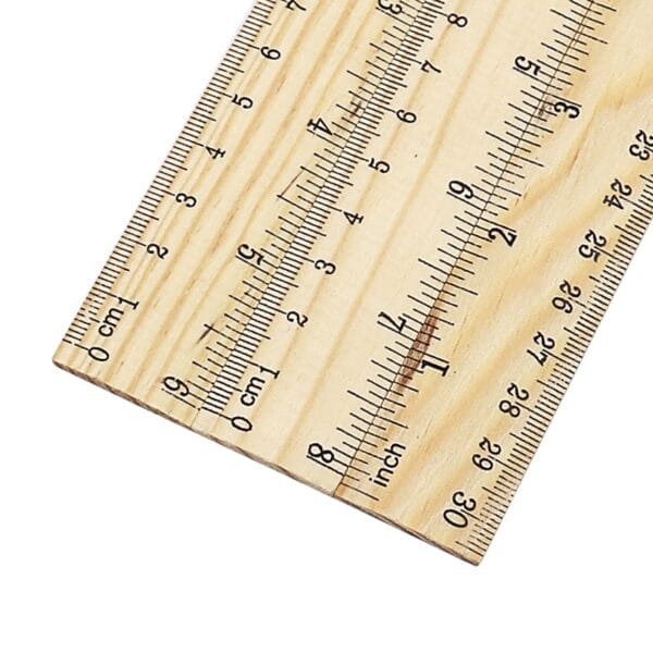 AUTO-DRAFT: Close-up of a wooden ruler showing both centimeter and inch markings.