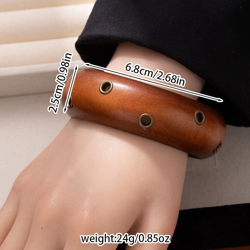 Black Wooden Bangle Cuff: Wide studded wooden bracelet with metal accents. Dimensions: 6.8cm x 2.5cm, weight: 24g.