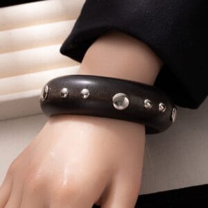 Black Wooden Bangle Cuff: Wide studded wooden bracelet on wrist