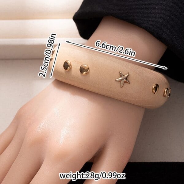 Black Wooden Bangle Cuff: Wide studded wooden bracelet with gold accents.