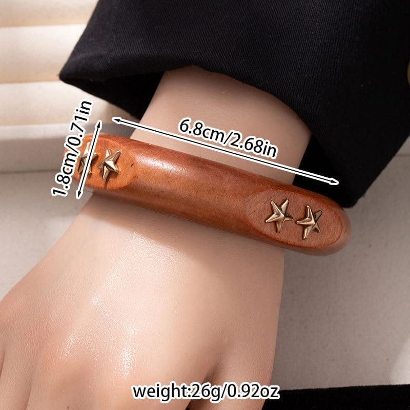 Black Wooden Bangle Cuff: Wide studded wooden bracelet with gold star accents.