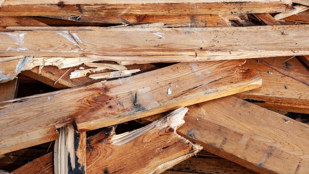 Pile of broken wood pieces, relevant to the question: Is wood a recyclable material?