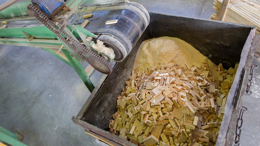Wood recycling: Wood scraps and sawdust being processed.