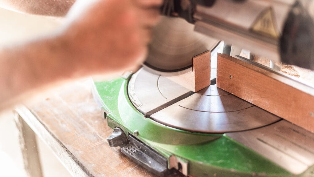 Miter saw cutting wood for a DIY jewelry box.