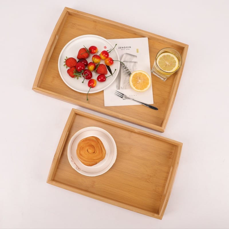 Large Personalised Wooden Butler Tray: Bamboo serving trays with fruit, pastry, drink, and magazine.