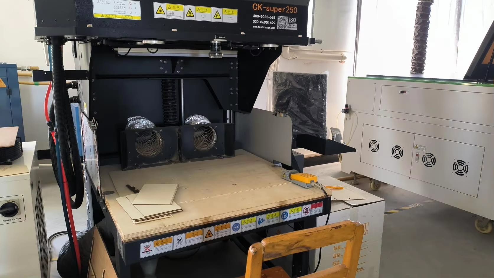 CK-super 250 laser cutter in a workshop setting, ready for use.