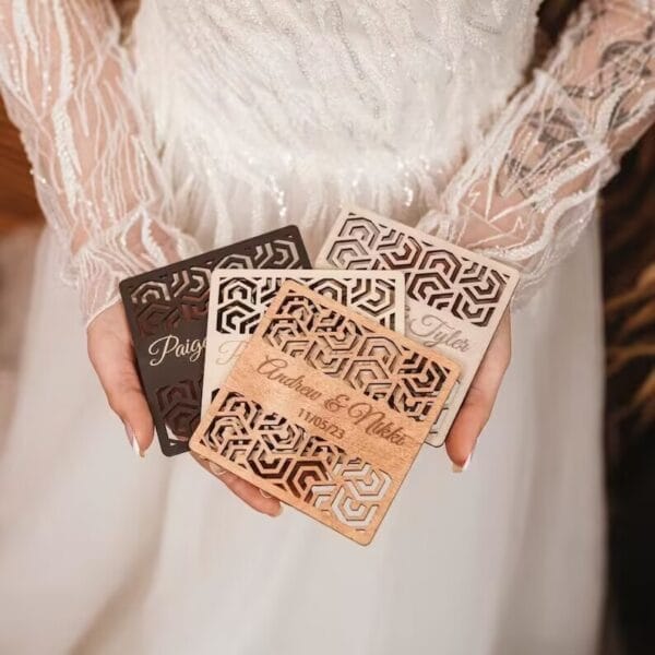 Bride holding personalized wooden coasters wedding favors. Laser-cut geometric design, custom guest gifts.