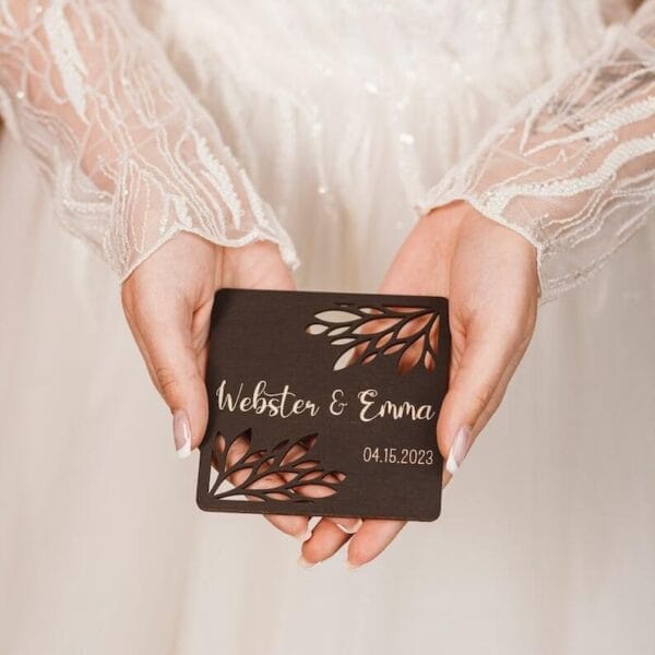 Personalized Wooden Coaster: "Webster & Emma" wedding favor with laser-cut floral design and date 04.15.2023.