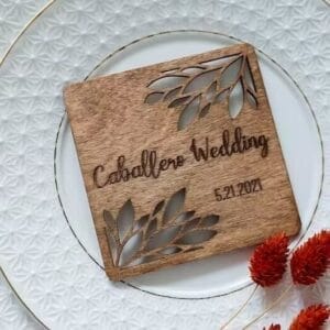 Personalized Wooden Coaster Wedding Favor with "Caballero Wedding" and date, floral laser-cut design.