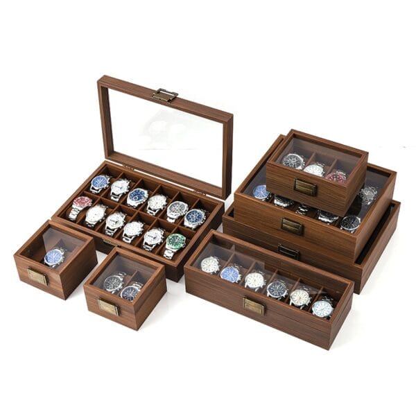 Wooden watch boxes in various sizes, some with glass tops displaying watches inside.