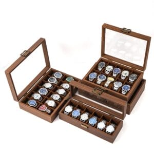 AUTO-DRAFT: Three wooden watch boxes with clear glass tops displaying a collection of wristwatches