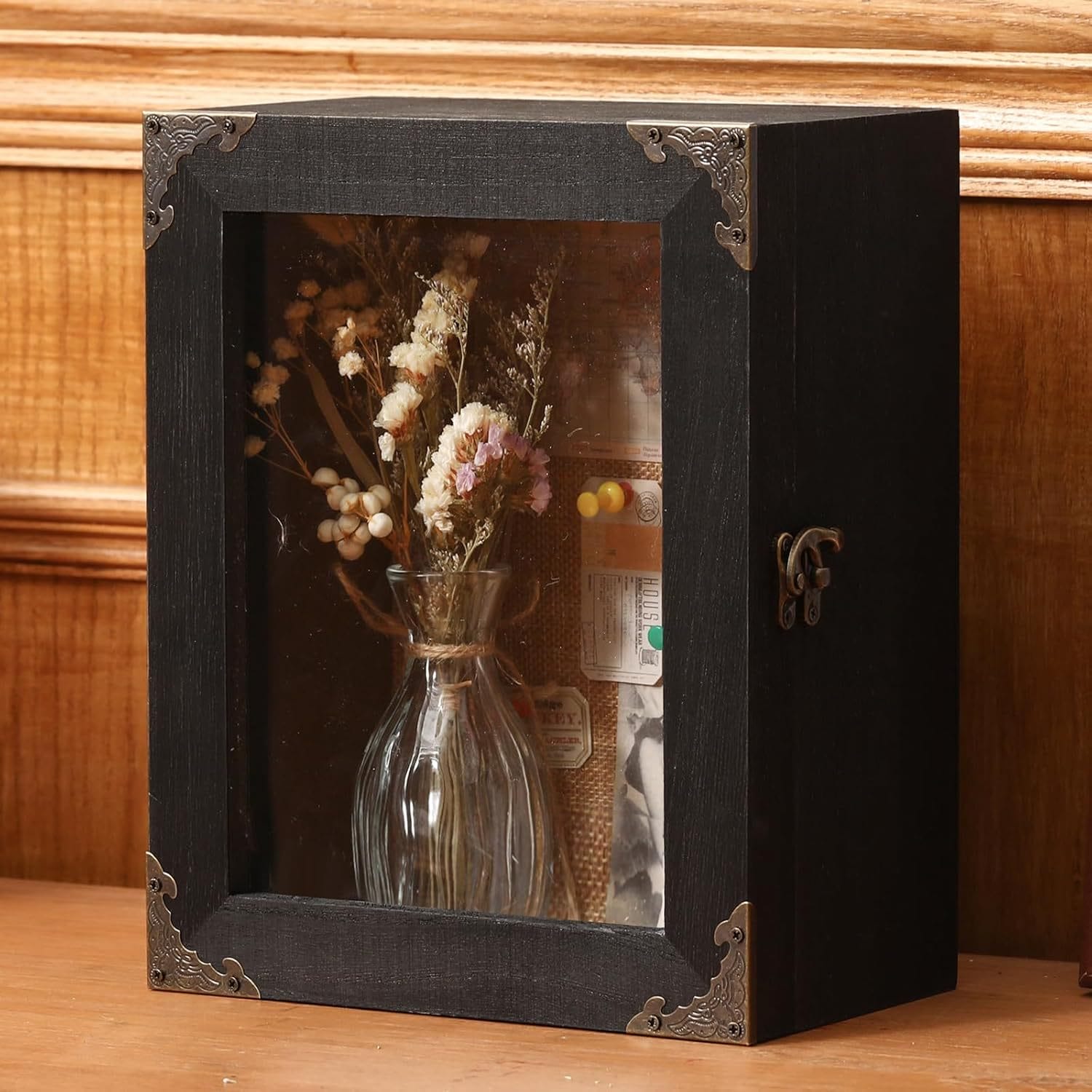 Shadow box with dried flowers in a vase, vintage-style hardware.
