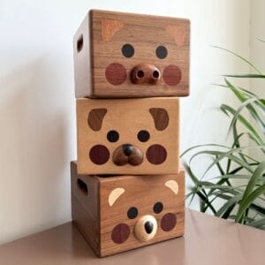 Stacked wooden animal boxes: pig, bear, and dog. Cute storage containers.