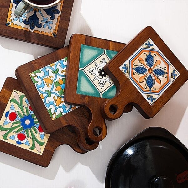 Decorative tile trivets with wooden handles, featuring colorful geometric and floral designs.