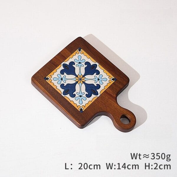 Wooden trivet with blue floral tile inlay and handle. Decorative kitchen hot pad.