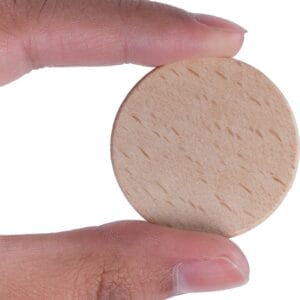 Blank Beech Wooden Nickel: Unfinished wooden coin held between fingers, ready for customization as a token.