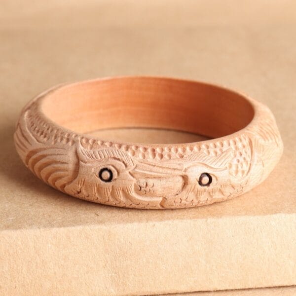 AUTO-DRAFT: Wooden bangle featuring intricate carved fish design