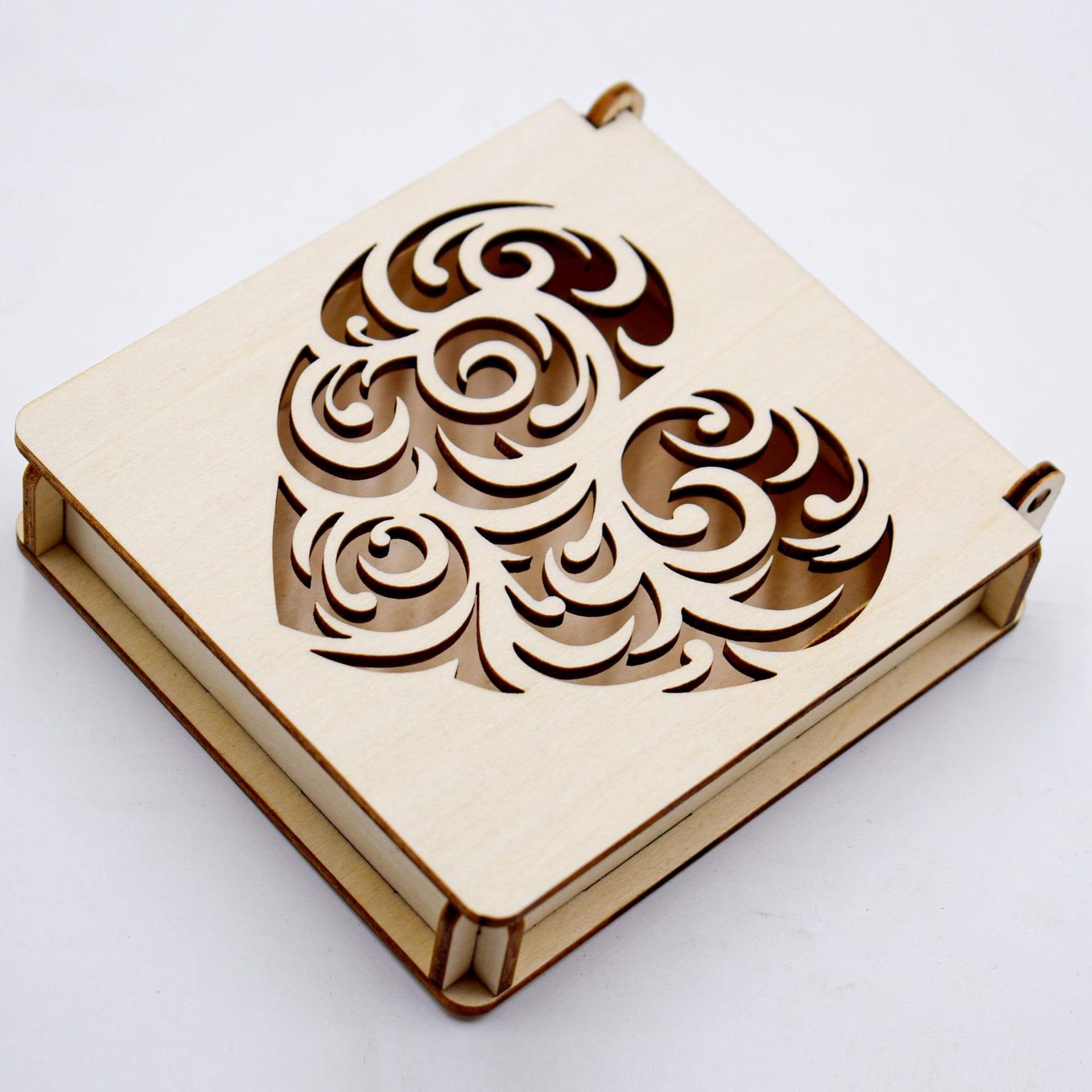 Carved wooden box with laser-cut heart design. Decorative storage for jewelry or keepsakes.