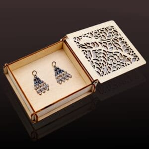 Earrings in a custom carved wooden box. Laser-cut design by Wholesale Manufacturer.