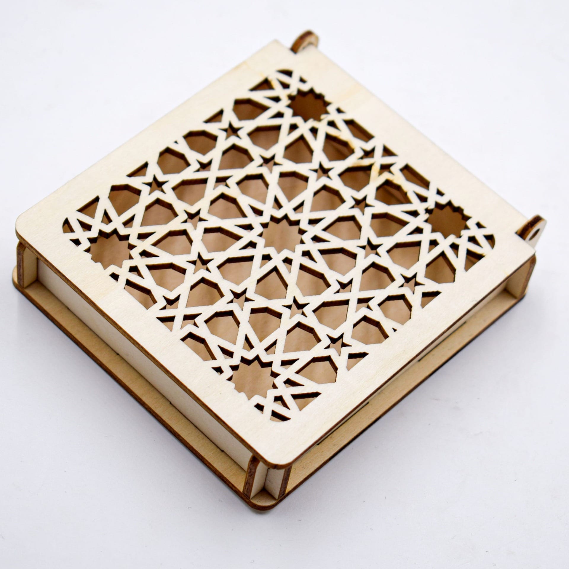 Custom Carved Wooden Box: Laser-cut square carved wooden box with geometric star pattern.