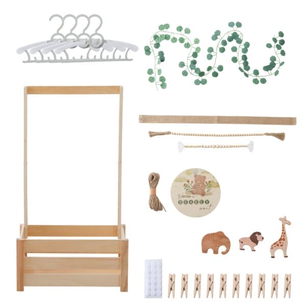 Wooden children's clothing rack with hangers, eucalyptus garland, and animal decorations