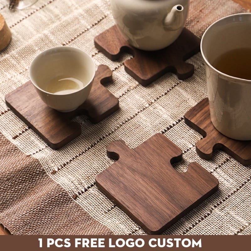 AUTO-DRAFT wooden puzzle piece coasters with tea cups and teapot on woven placemat.