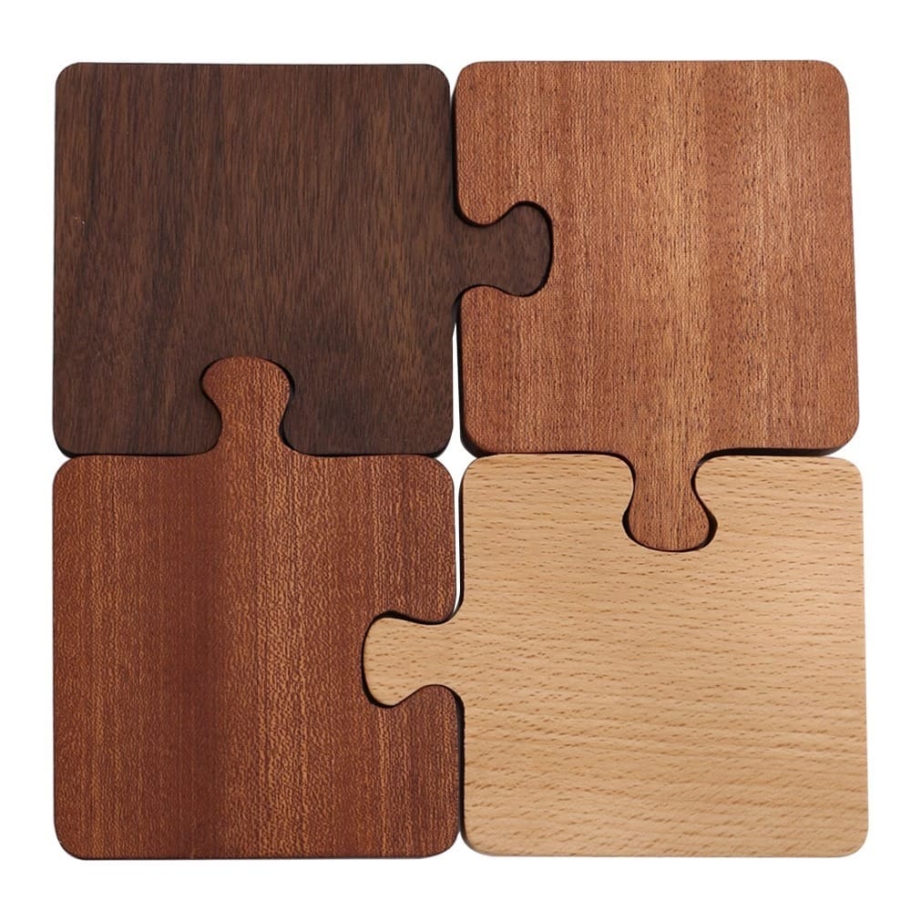 Wooden puzzle coasters, set of four, in varying wood tones.