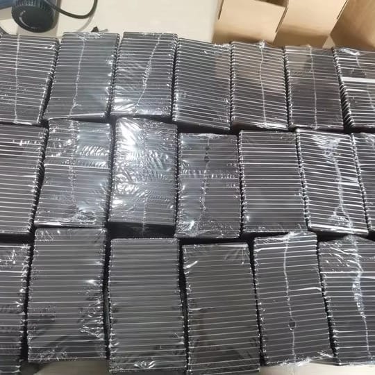 Stacks of black AUTO-DRAFT products, individually wrapped in clear plastic.