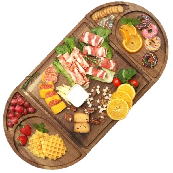 Wooden charcuterie board with meat rolls, cheese, fruit, waffles, donuts, crackers, nuts, and yogurt dip.
