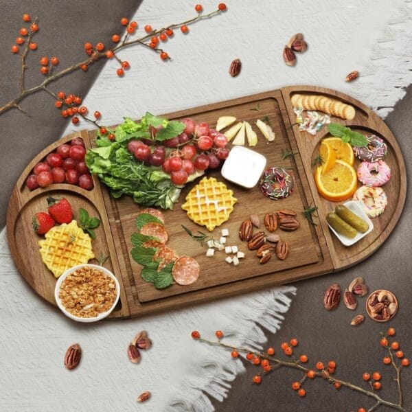 Wooden charcuterie board with grapes, waffles, cheese, salami, nuts, pickles, and donuts.