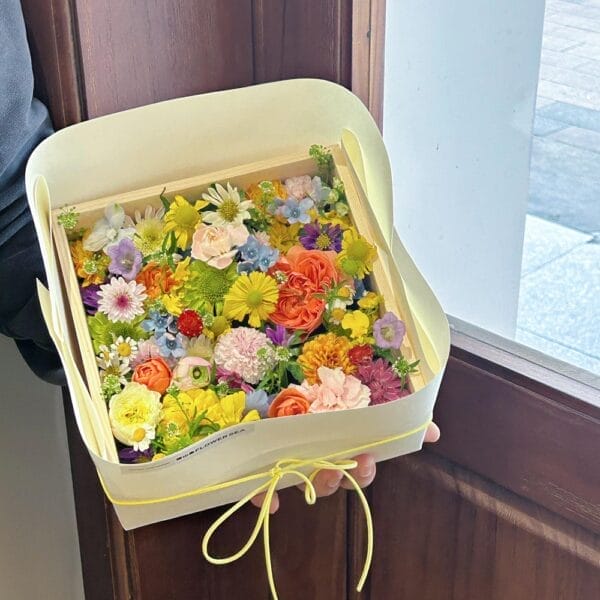 Mini Wooden Boxes Wholesale: Square box filled with vibrant, assorted colorful flowers.