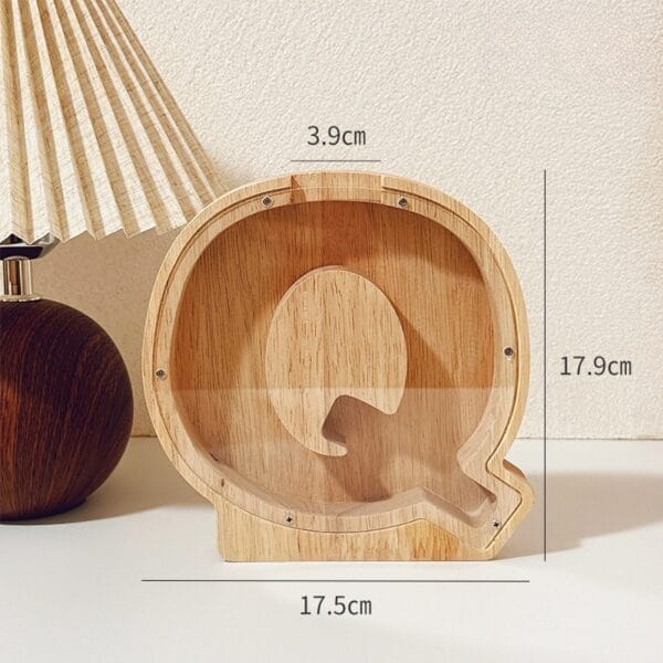 Wooden letter Q piggy bank with 17.9cm height and 17.5cm width