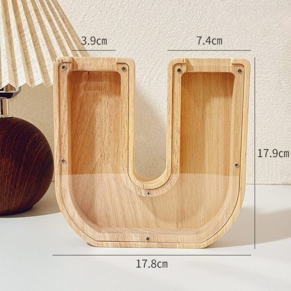 U-shaped wooden coin bank with labeled dimensions: 17.9cm height, 17.8cm width, 3.9cm and 7.4cm top widths.