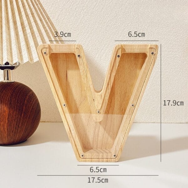 AUTO-DRAFT: Wooden letter V coin bank with dimensions 17.9cm height, 17.5cm width