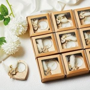Heart-shaped wooden candlesticks, wholesale wedding favors. Adorned with feathers and "love" charm.