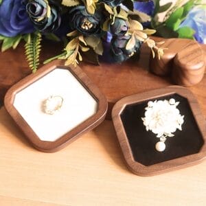 Wooden jewelry boxes displaying a ring and brooch. Elegant storage for precious jewelry.